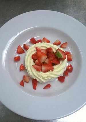 A picture of Meringue nests, with Chantilly cream and strawberries.