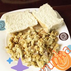 A picture of Eggs sauce with bread.