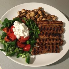 A picture of Grilled Kebab with Mushrooms & Valerian salad.