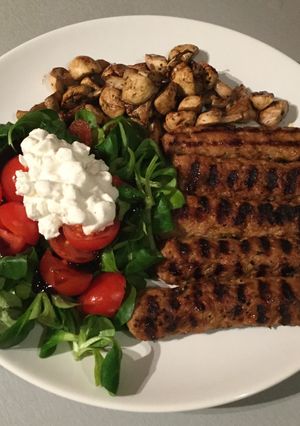 A picture of Grilled Kebab with Mushrooms & Valerian salad.