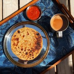 A picture of Sattu Paratha with Tamatar Lahsun Chutney.