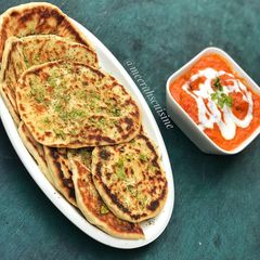 Naan bread and buttered chicken A picture of Naan bread and buttered chicken.