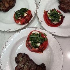 A picture of Grilled Filets with Herb Butter and Caprese Tomatoes.