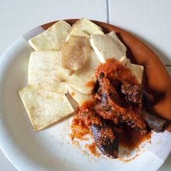 A picture of Fried yam with pomo stew.