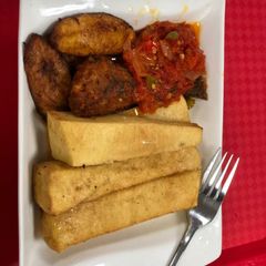 A picture of Fried yam and plantain with pepper sauce.