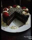 Chocolate cake with chocolate ganache and whipped cream icing