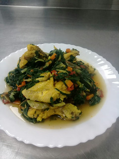 A picture of Boiled chicken with spinach.