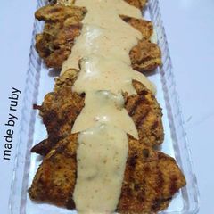 A picture of Chicken steak with white sauce.