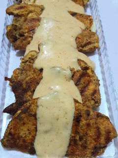 A picture of Chicken steak with white sauce.