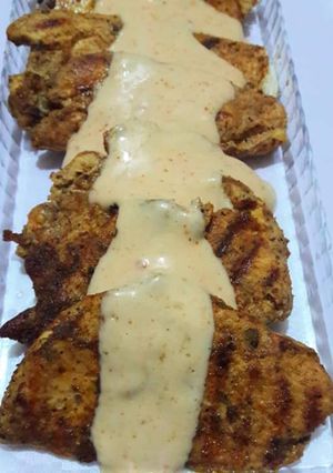 A picture of Chicken steak with white sauce.
