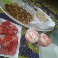Chinese rice, pizza, watermelon and whipped cream A picture of Chinese rice, pizza, watermelon and whipped cream.