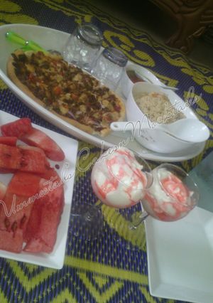 A picture of Chinese rice, pizza, watermelon and whipped cream.