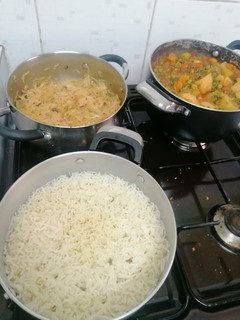 A picture of Mixed vegetable stew with minced meat, rice and a side of cabbage.