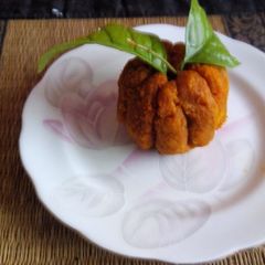 A picture of Orange shaped coconut ladoo.
