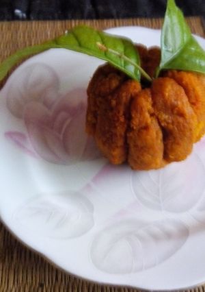 A picture of Orange shaped coconut ladoo.