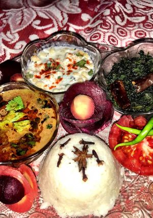 A picture of Gaith ki dal, chawal, palak ki sabaji, raita aur salad.(thali).