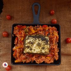 A picture of Paneer steak with cherry tomato rice.