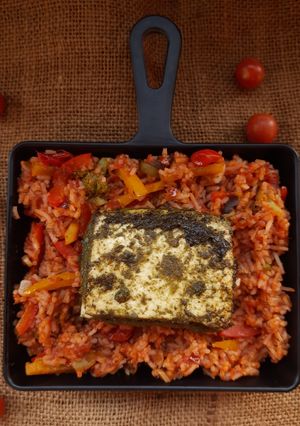 A picture of Paneer steak with cherry tomato rice.