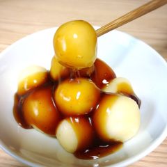 A picture of Japanese dessert Mochi with sweet soy starchy sauce.