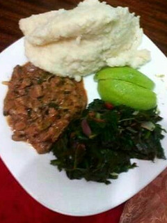 A picture of Ugali, spinach, avocado with wet fried beef.