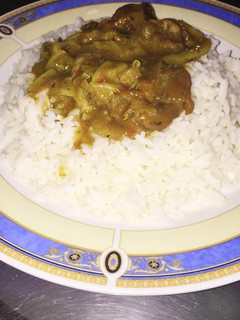 A picture of White rice with vegetable soup.