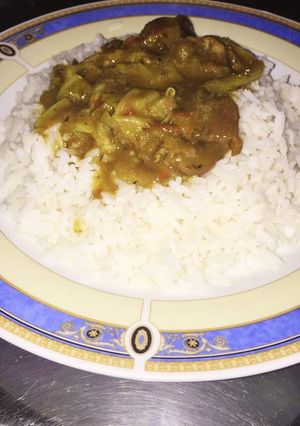 A picture of White rice with vegetable soup.