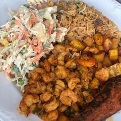 A picture of Rice excurted by shrimps, plantain and salad and mackerel.