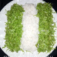 A picture of Nigerian rice with salad.