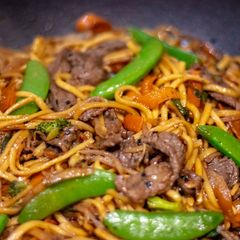 A picture of Easy stir fried honey and soysauce beef with egg noodles.