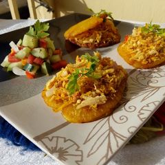 A picture of Patacones or Tostones with minced chicken topping.