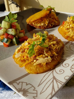 A picture of Patacones or Tostones with minced chicken topping.