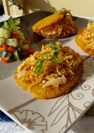 A picture of Patacones or Tostones with minced chicken topping.