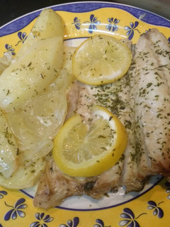 Una foto de Lubina al horno con patatas y cebolla