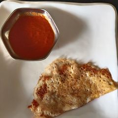 A picture of Rice Dosa(left over) with onion red chutney.