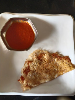 A picture of Rice Dosa(left over) with onion red chutney.