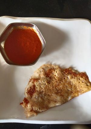 A picture of Rice Dosa(left over) with onion red chutney.