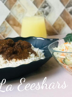 A picture of White rice,stew and simple salad.