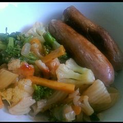 A picture of Cauliflower,broccoli and pasta served with sausages.