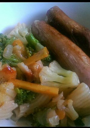A picture of Cauliflower,broccoli and pasta served with sausages.