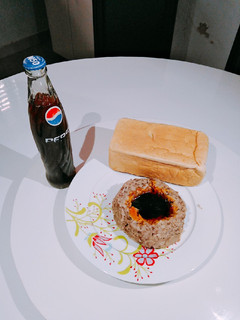 A picture of Ewa agoyin and agege bread and pepsi.
