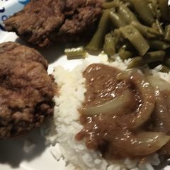 A picture of Chicken Fried Hamburger Steak and an Onion Gravy.