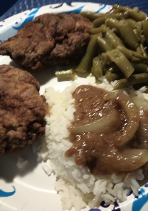 A picture of Chicken Fried Hamburger Steak and an Onion Gravy.
