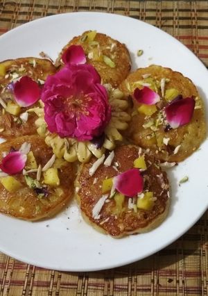 A picture of Pineapple Malpua in Gulab Chashni.