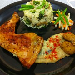 A picture of Pan seared chicken, served with herb rice & mashed potatoes.