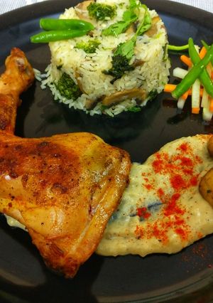 A picture of Pan seared chicken, served with herb rice & mashed potatoes.