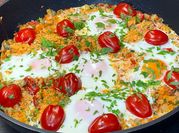 A picture of fried egg with tomatoes
