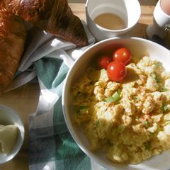 A picture of A simple morning breakfast with scrambled eggs & fresh scallions.