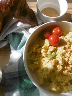 A picture of A simple morning breakfast with scrambled eggs & fresh scallions.