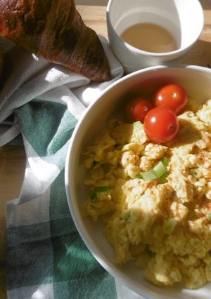 A picture of A simple morning breakfast with scrambled eggs & fresh scallions.