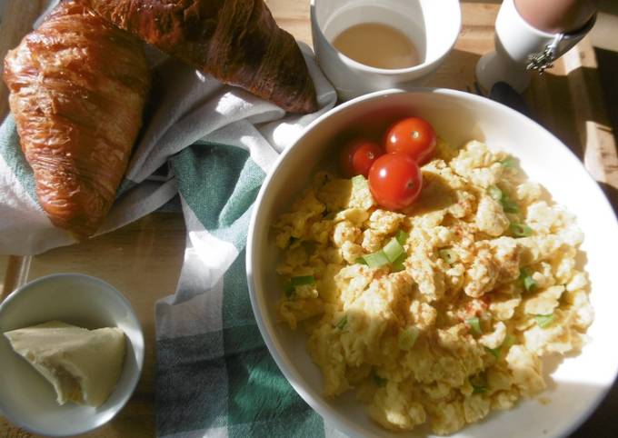 A simple morning breakfast with scrambled eggs & fresh scallions